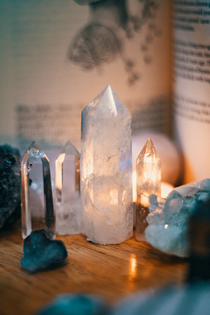 Beautiful quartz crystals displayed on a wooden table with warm ambient lighting.